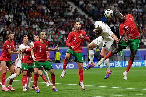 Nuno Mendes heads the ball next to Jaka Bijol